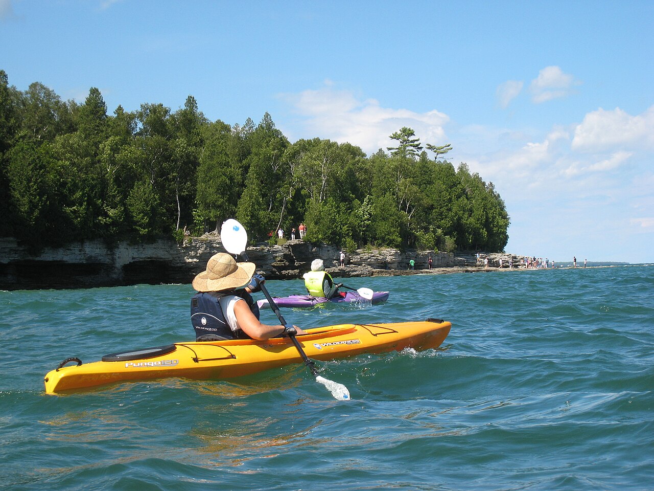 Kayakers along the rocky Lake Michigan shoreline at Cave Point County Park in Door County